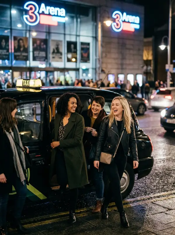 Group of friends getting out of a taxi outside the 3Arena at night
