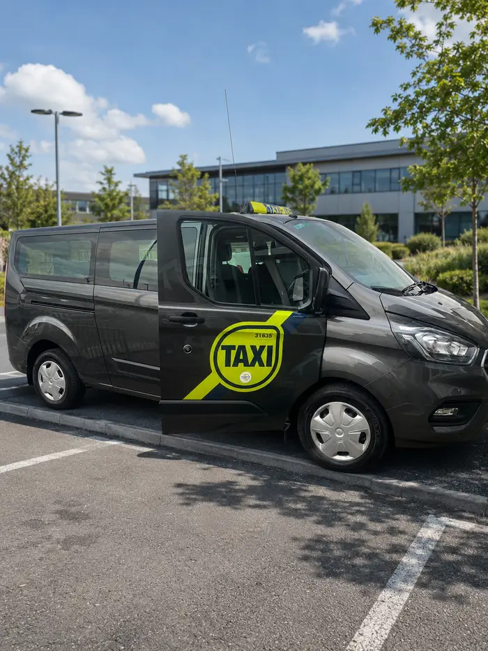 Tony's Cabs minibus with the side door open, showing seating for a group