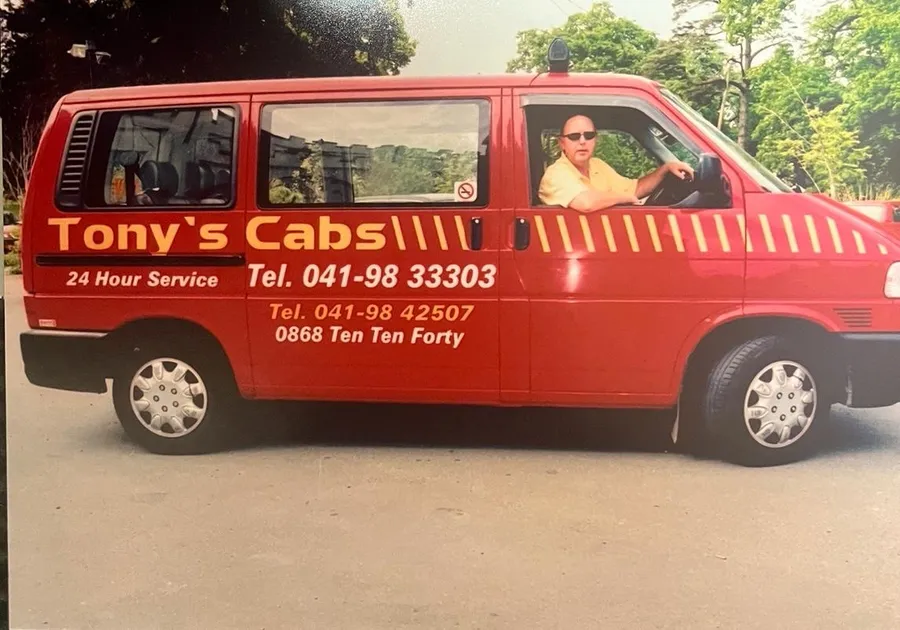 Tony, founder of Tony's Cabs, behind the wheel of the original Tony's Cabs minibus